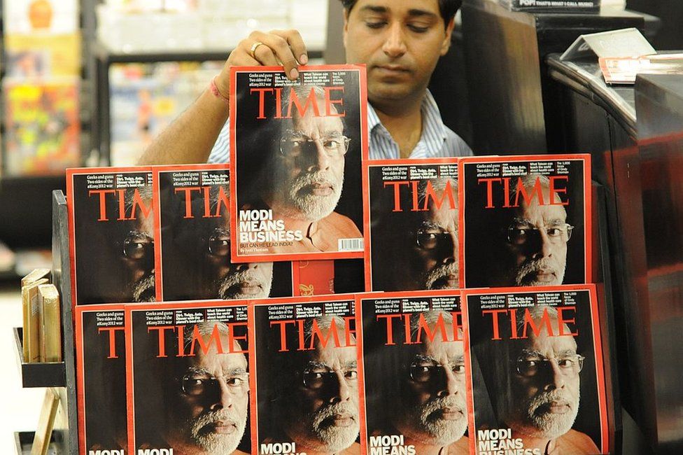 An Indian salesman arranges copies of Time magazine featuring a cover photo of Gujarat Chief Minister Narendra Modi at a store in Ahmedabad on March 18, 2012