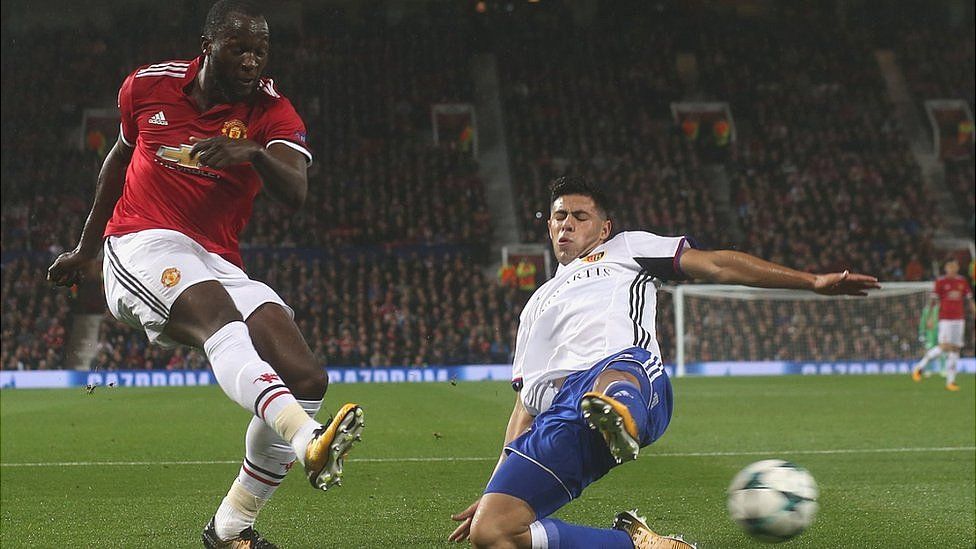 Romelu Lukaku of Manchester United in action with Blas Riveros of FC Basel during the UEFA Champions League group A match