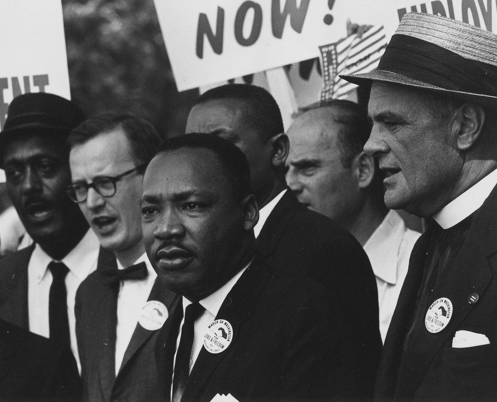Dr. Martin Luther King stands with others at a march