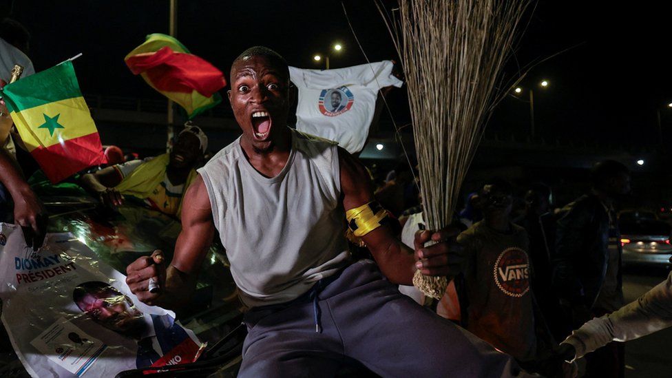 A Supporter of Senegalese presidential candidate Bassirou Diomaye Faye celebrates early results showing that Faye is leading initial presidential election tallies, in Dakar, Senegal, March 24, 2024