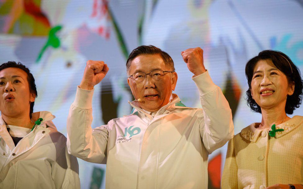 Standing in the centre of a stage, Taiwan People's Party leader and presidential candidate Dr. Ko Wen-jie clinches his fists during a political rally organised by his party.