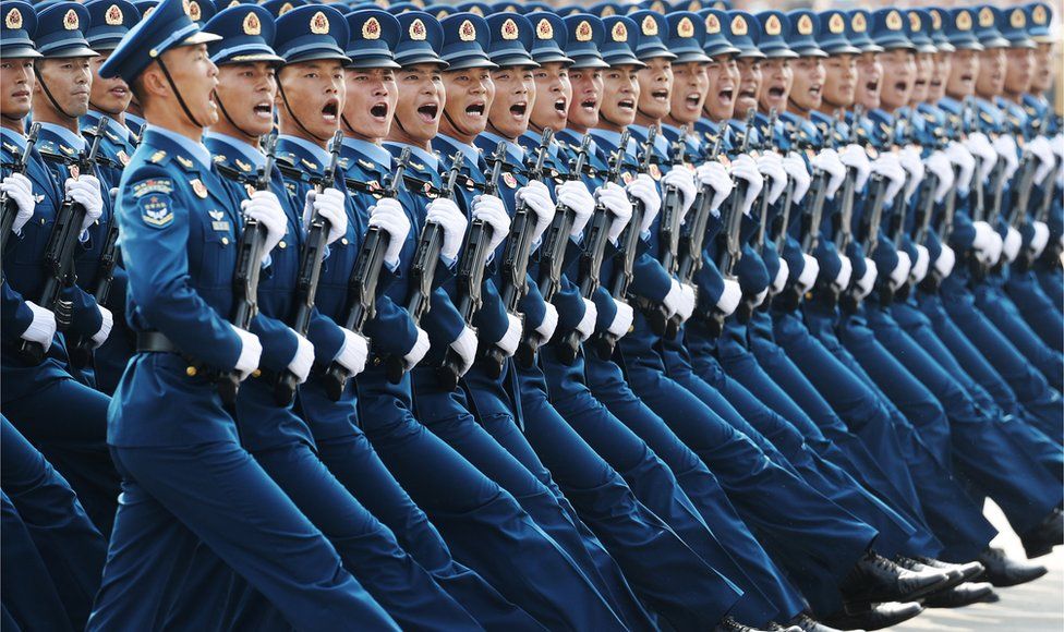 Troops march in blue uniform in Tiananmen Square on 1 October 2019.