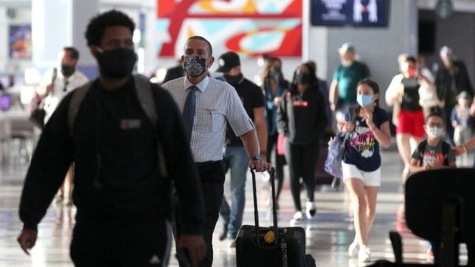 Travellers wearing face masks in an airport