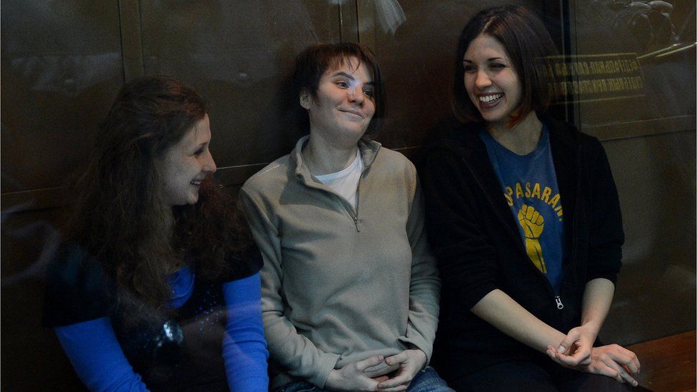 From left to right, Yekaterina Samutsevich, Maria Alyokhina and Nadezhda Tolokonnikova sit