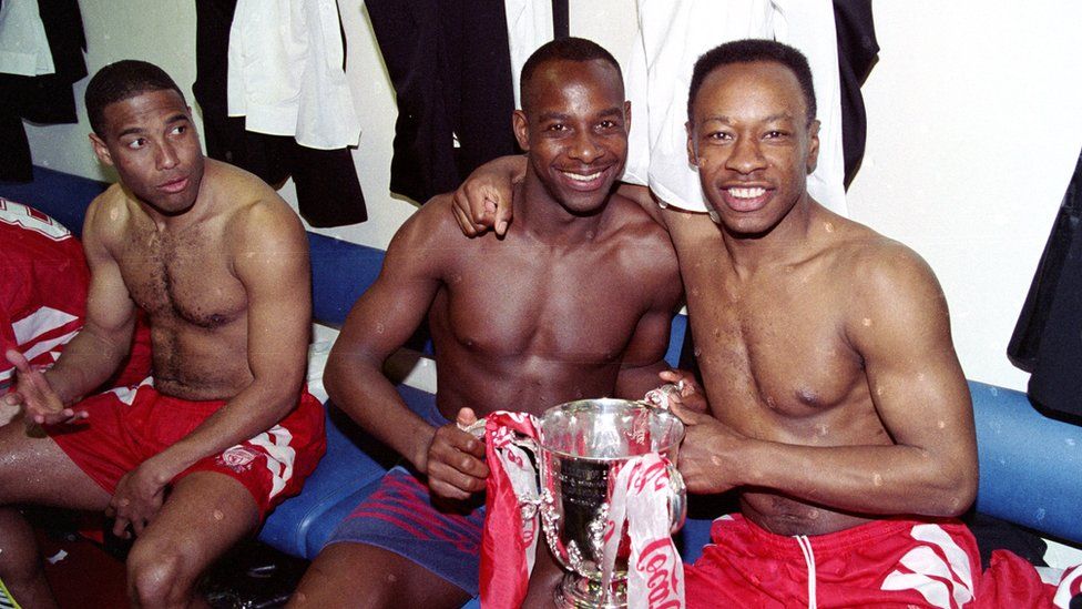 LFC v Bolton Wanderers in the Coca Cola cup final at Wembley, won by the Reds 3-1. John Barnes (L), Micheal Thomas and Mark Walters (R) celebrate with the cup in the dressing room. on April 2, 1995