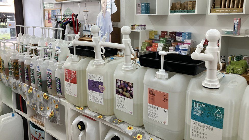 The interior of a refill shop with household products - such as toilet cleaner and hand soap - in huge dispensers