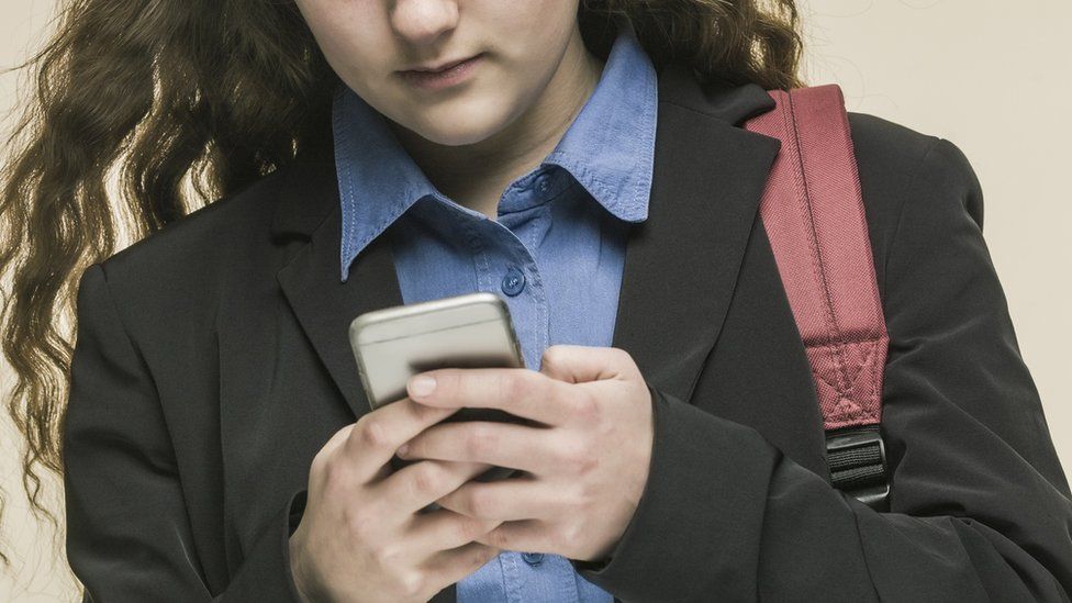 Girl in blazer with phone
