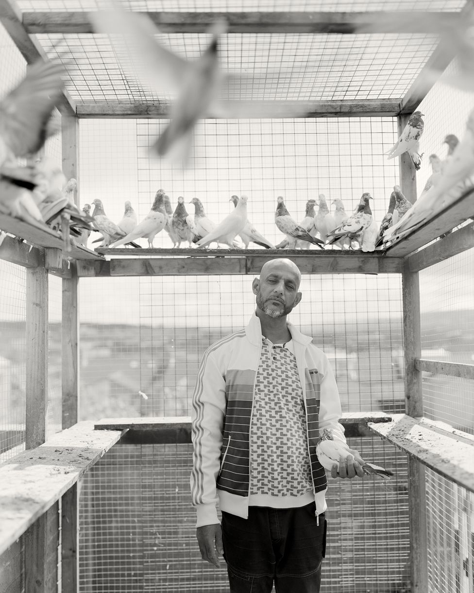 Black and white portrait of a man surrounded by birds