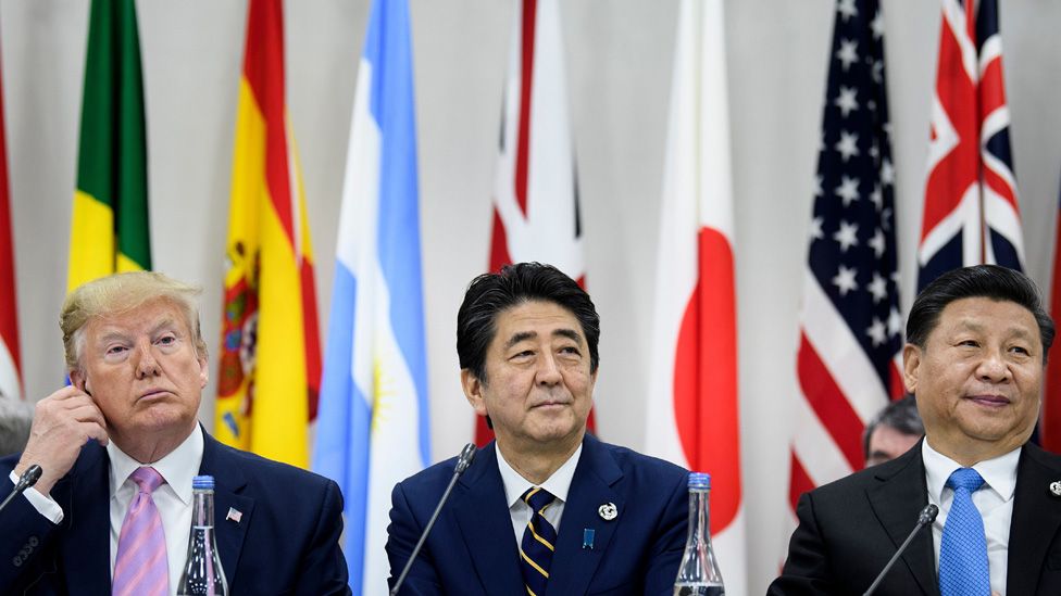 US President Donald Trump, Japan's Prime Minister Shinzo Abe and China's President Xi Jinping attend a meeting at the G20 Summit in Osaka