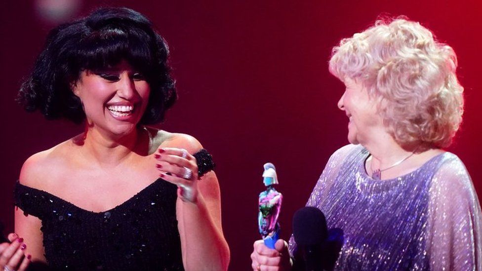 Raye on stage after winning the award for Song of the Year during the Brit Awards, with Jo Hamilton