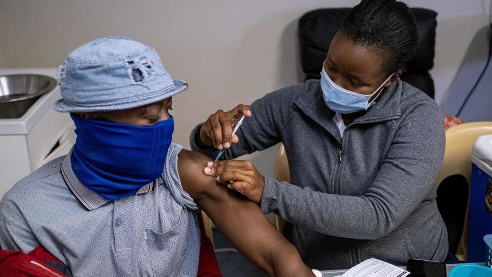 A patient gets vaccinated against COVID-19 at the Witkoppen clinic in Johannesburg on December 8, 2021