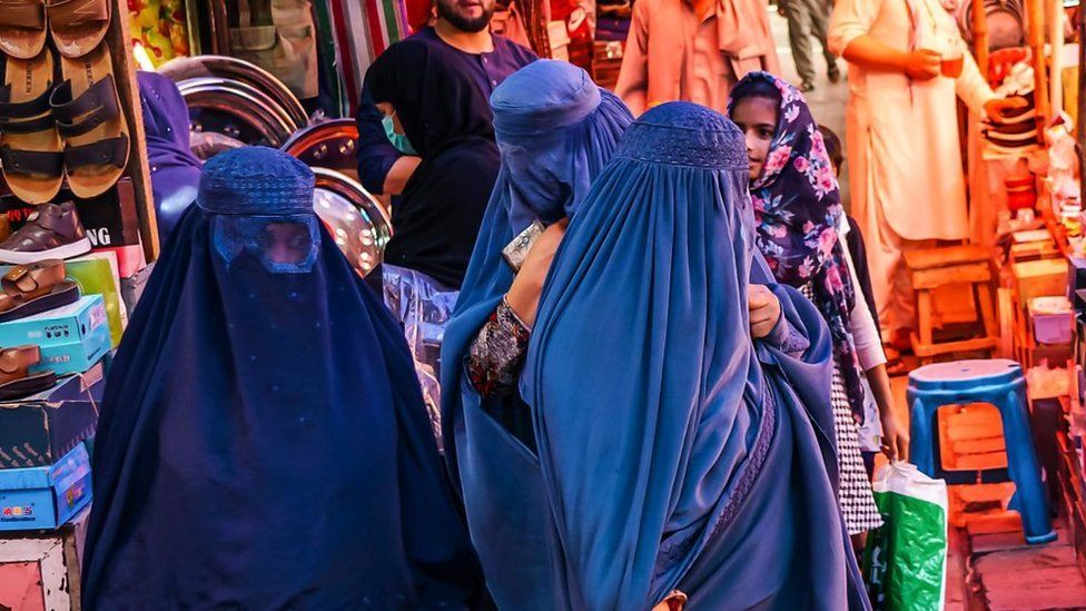 Women in Kabul market, wearing blue burqas