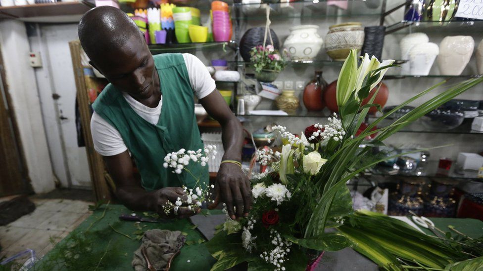 A man arranging flowers in Abidjan, Ivory Coast - Monday 13 February 2017