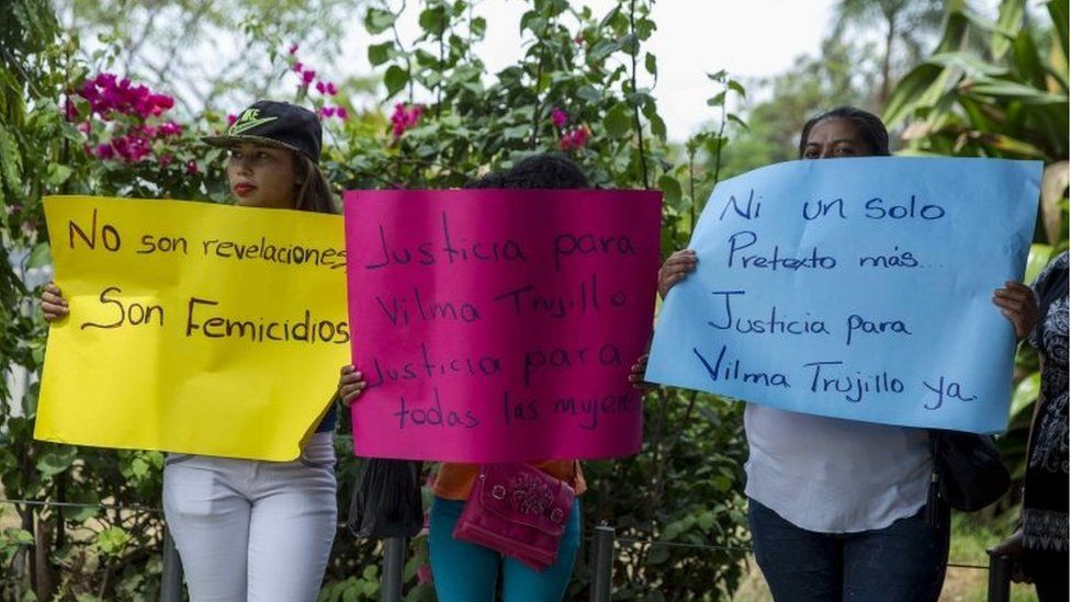 Three women take part in a protest outside the courtrooms of Managua, Nicaragua, 02 May 2017, holding colourful signs calling for justice for Vilma Trujillo