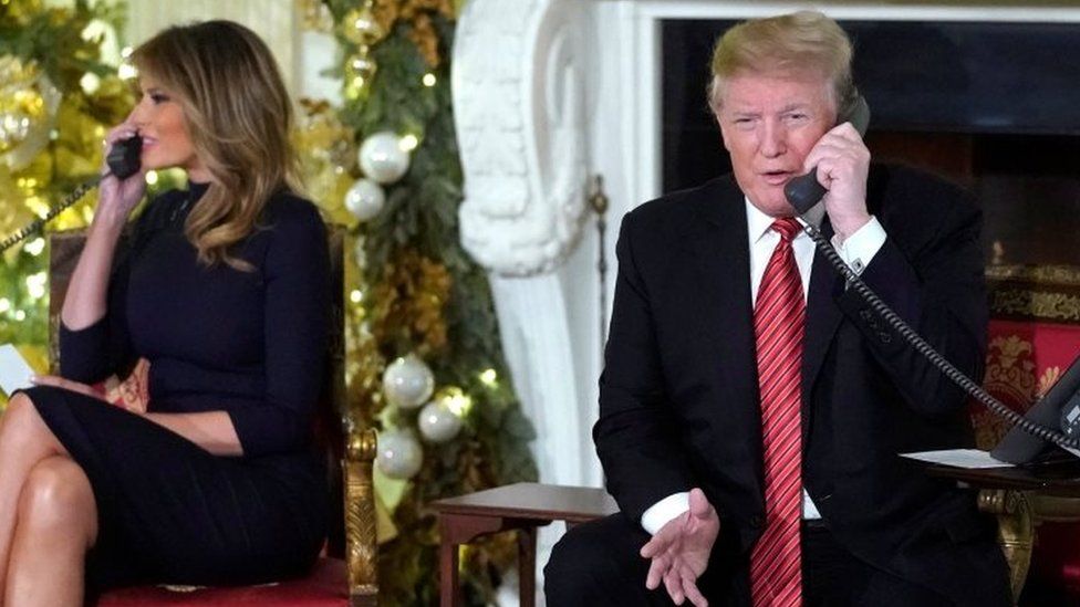 Melania Trump and Donald Trump take calls from American children in the White House, Washington. Photo: 24 December 2018
