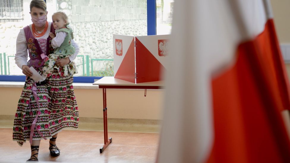 A women and child at a polling station in Poland