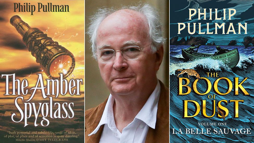 Philip Pullman between the book jackets for The Amber Skyglass and La Belle Sauvage