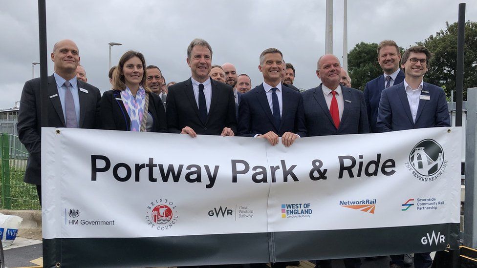 Group of people holding up a sign that says Portway Park & Ride