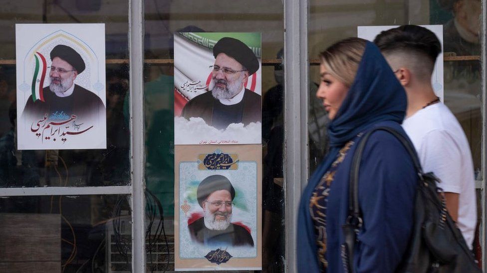 A couple walks past Ebrahim Raisi's election posters in southern Tehran, Iran (June 4, 2021)