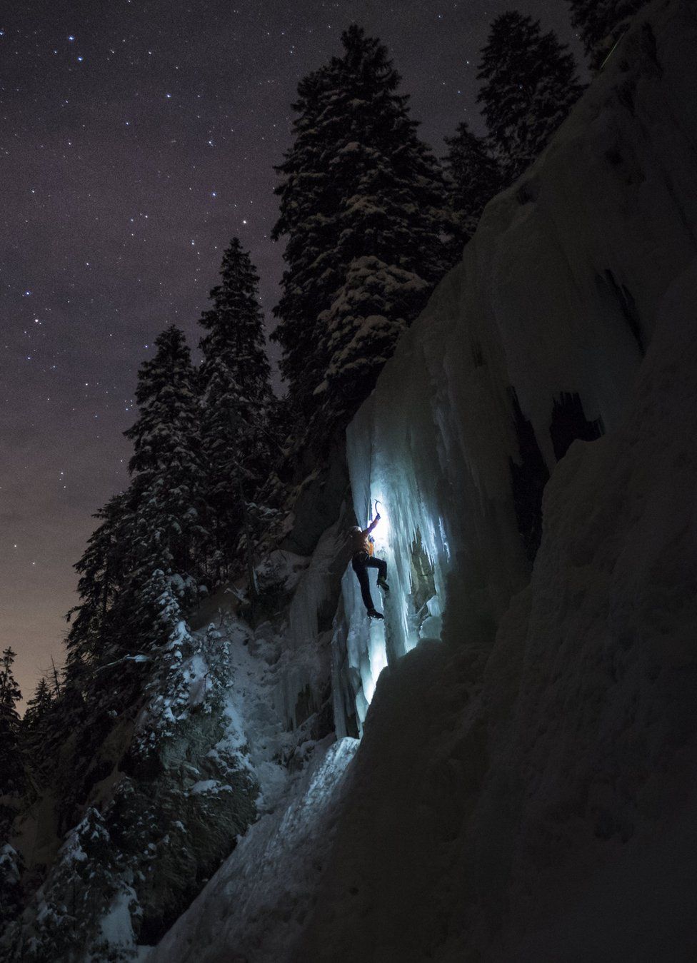 A climber moves up an ice cascade in Switzerland.