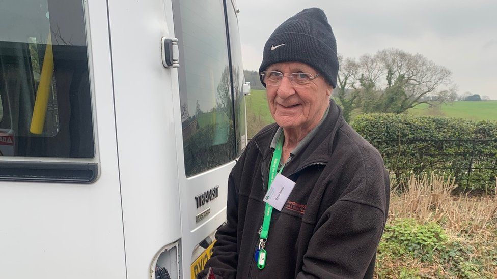 Dae Senior standing by a white van at Children's Hospice South West at Wraxall