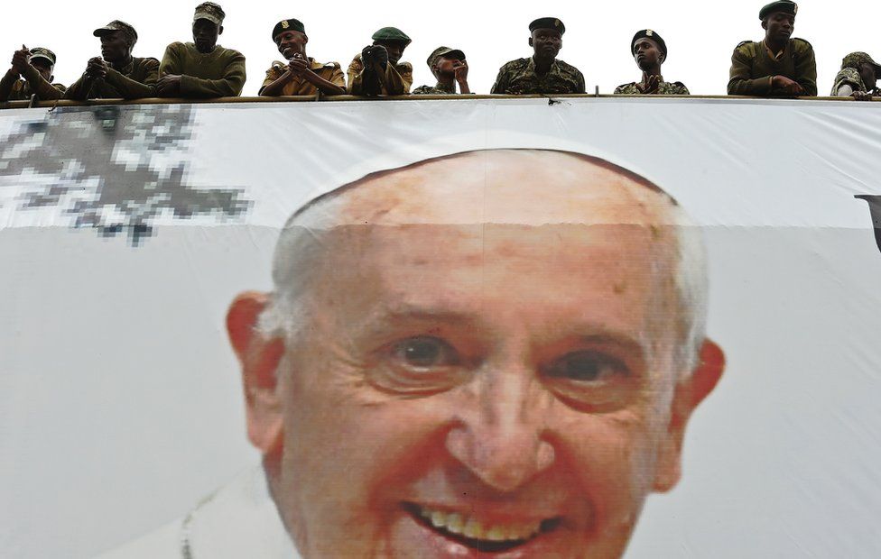Members of Kenya's National Youth Service stand over an image of Pope Francis during his visit to Nairobi , Kenya - Thursday 26 November 2015