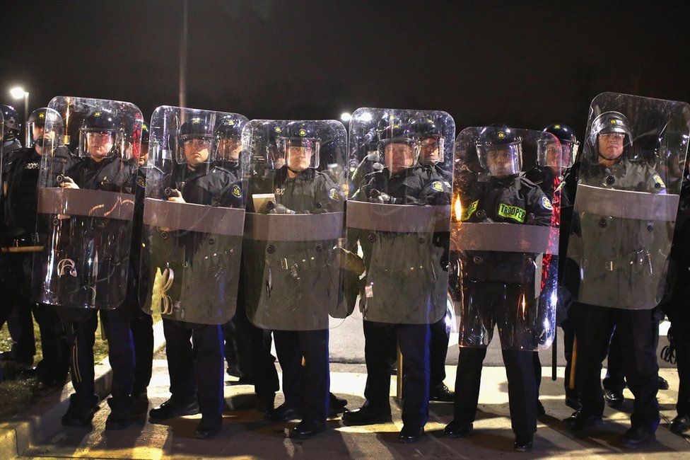 Police officers guard the Ferguson police department in November 2014