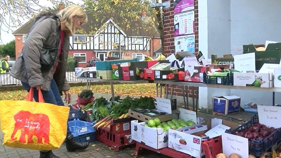 woman at fruit and veg stall