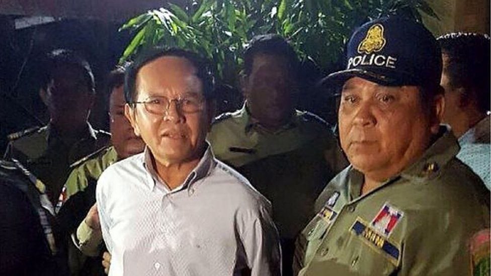 This file photo taken on September 3, 2017 shows Cambodian opposition leader Kem Sokha (L) being escorted by police at his home in Phnom Penh
