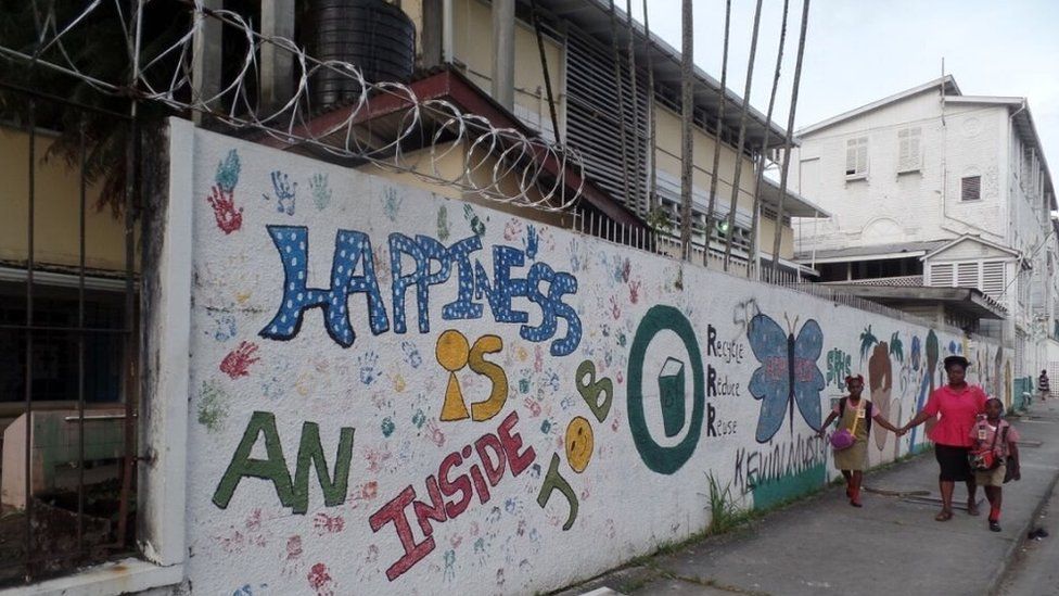 A mural in Georgetown reads: "Happiness is inside".