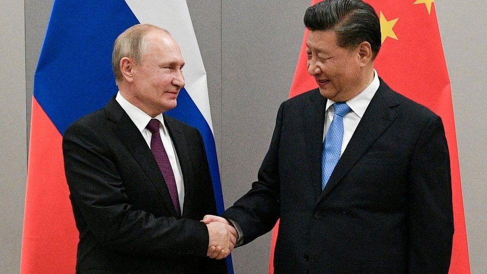 Vladimir Putin and Xi Jinping shake hands in Brazil in November 2019