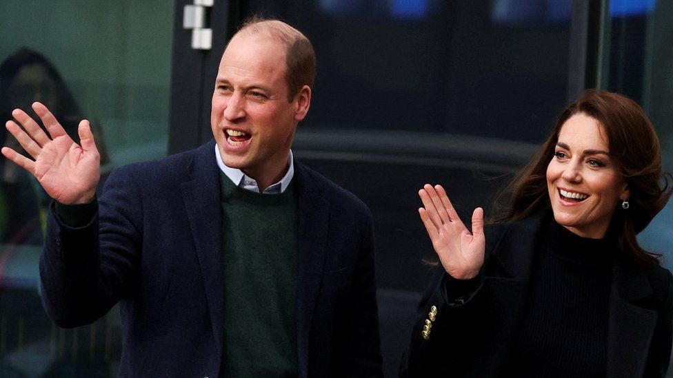 Prince William, Prince of Wales and Catherine, Princess of Wales wave as they visit the Royal Liverpool University hospital