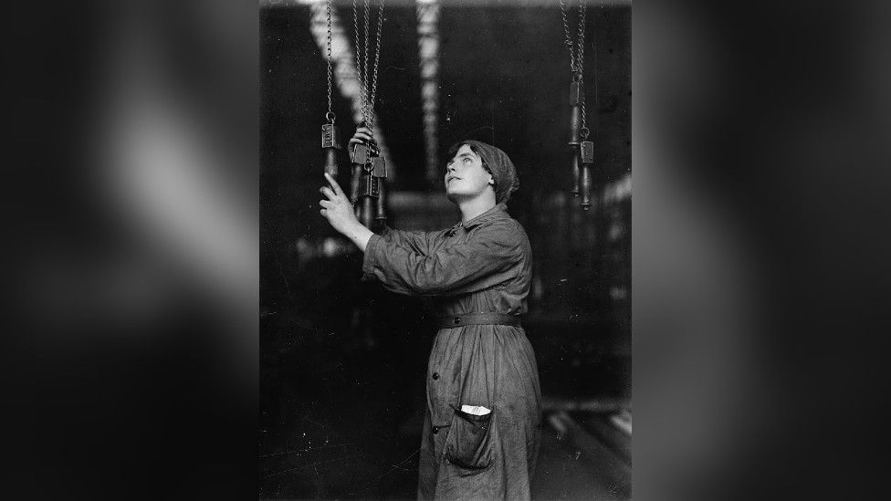 Woman operating an overhead electrical crane