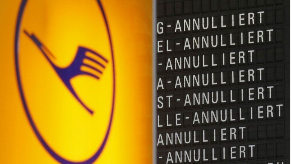 Lufthansa logo and cancellation flight board