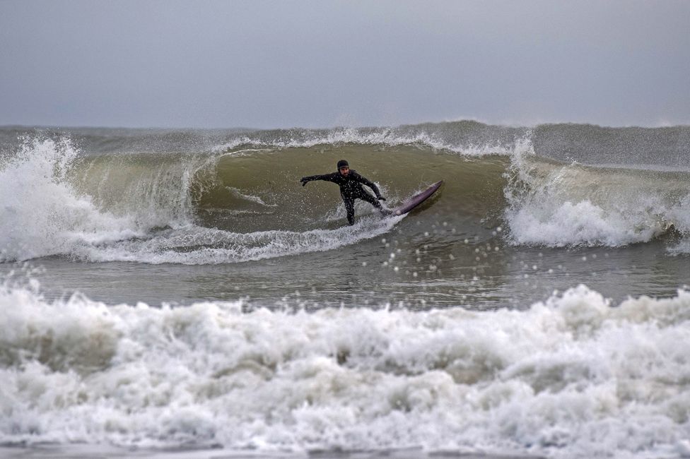 Surfers at Langland Bay, near Swansea, 14 January 2021