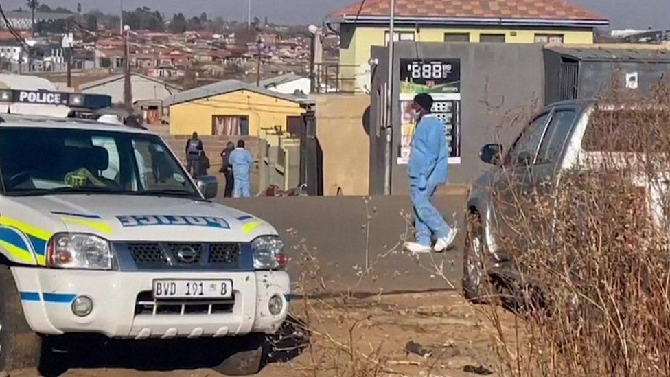 A police car parked in front of the bar where the shooting took place in Soweto