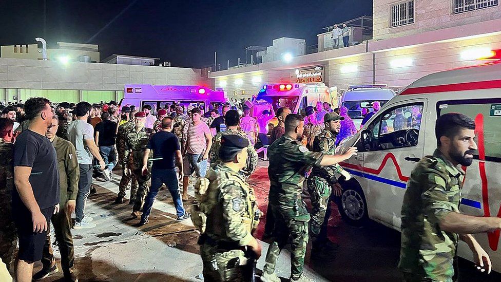 Soldiers and emergency responders gather around ambulances carrying wounded people after a fire broke out during a wedding at an event hall, outside the Hamdaniyah general hospital in Al-Hamdaniyah, Iraq on September 27, 2023. At least 100 people were killed and more than 150 injured when a fire broke out during a wedding at an event hall in the northern Iraqi town of Al-Hamdaniyah, according to state media and health officials, on September 27, 2023. (Photo by Zaid AL-OBEIDI / AFP) (Photo by ZAID AL-OBEIDI/AFP via Getty Images)