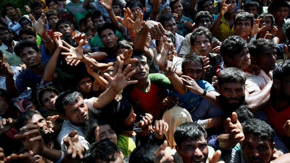 Rohingya stretch their hands to get aid supplies in Cox's Bazar, Bangladesh. Photo: 16 September 2017