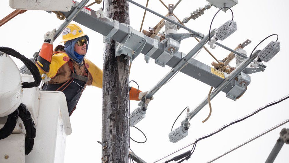 A worker repairs a power line in Austin, Texas, in February 2021