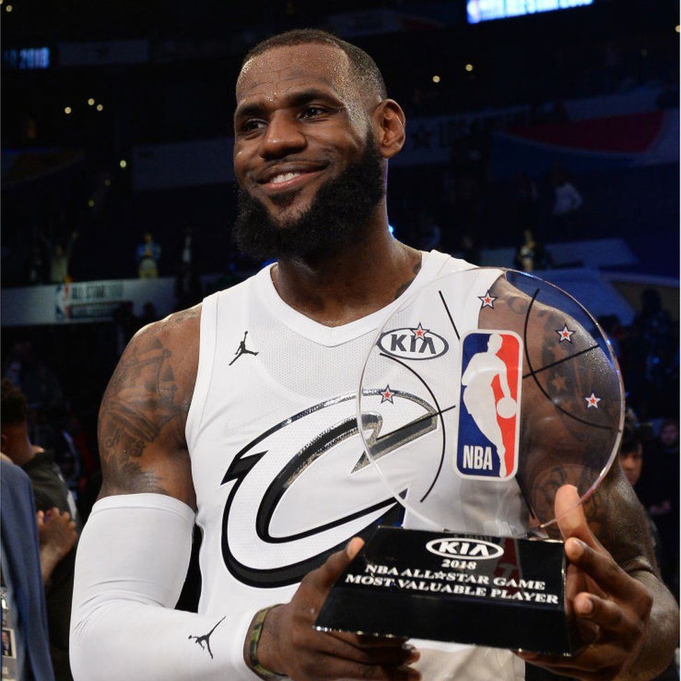 LeBron James holding the Most Valuable Player trophy
