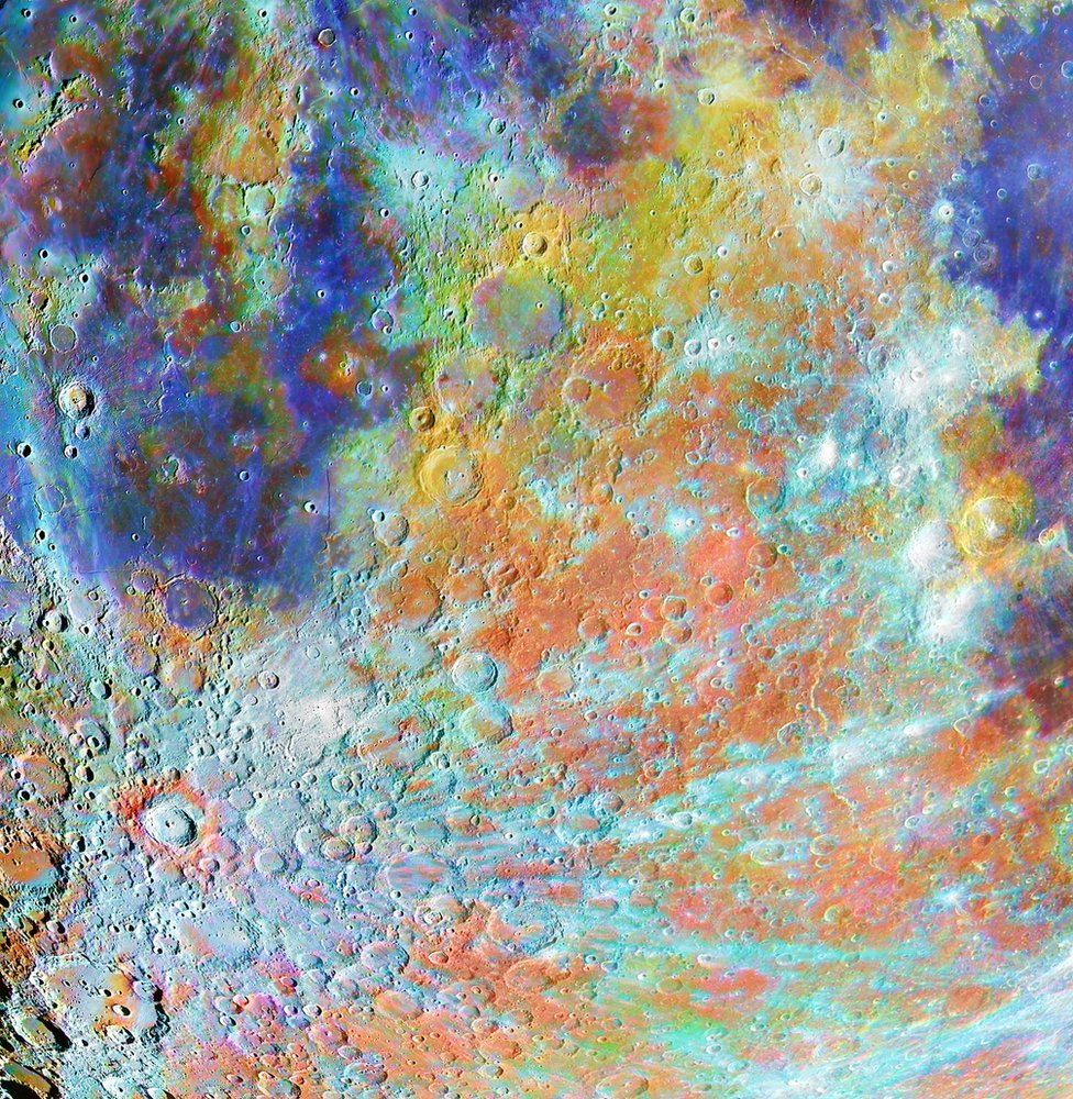 The surface of the moon showing craters with colours representing different chemical composition