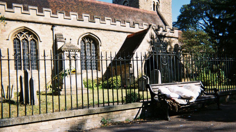 Bench with bedding on it outside a church in Bedford