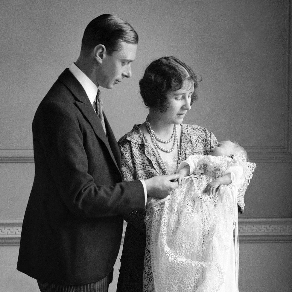 The Queen Mother (then the Duchess of York) with her husband, King George VI (then the Duke of York), and their daughter Princess Elizabeth at her christening