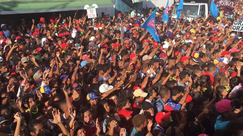 Supporters of Rafael Lacava raise their hands