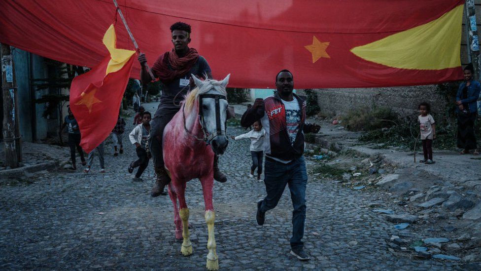 A man on a horse painted in colours of the Tigray flag poses as they celebrate the return of soldiers of Tigray People's Liberation Front (TPLF) fighters on a street in Mekele, the capital of Tigray region, Ethiopia, on June 29, 2021