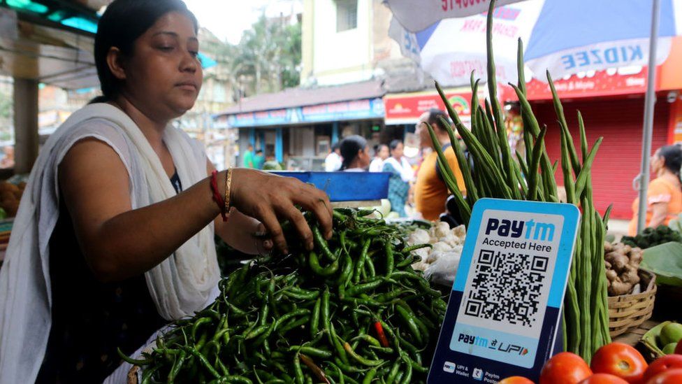 A vegetable vendor waits for customers displaying a barcode for Paytm, an Indian cell phone-based digital payment platform, at a market in Kolkata,India on July 04,2023. (Photo by Debajyoti Chakraborty/NurPhoto via Getty Images)