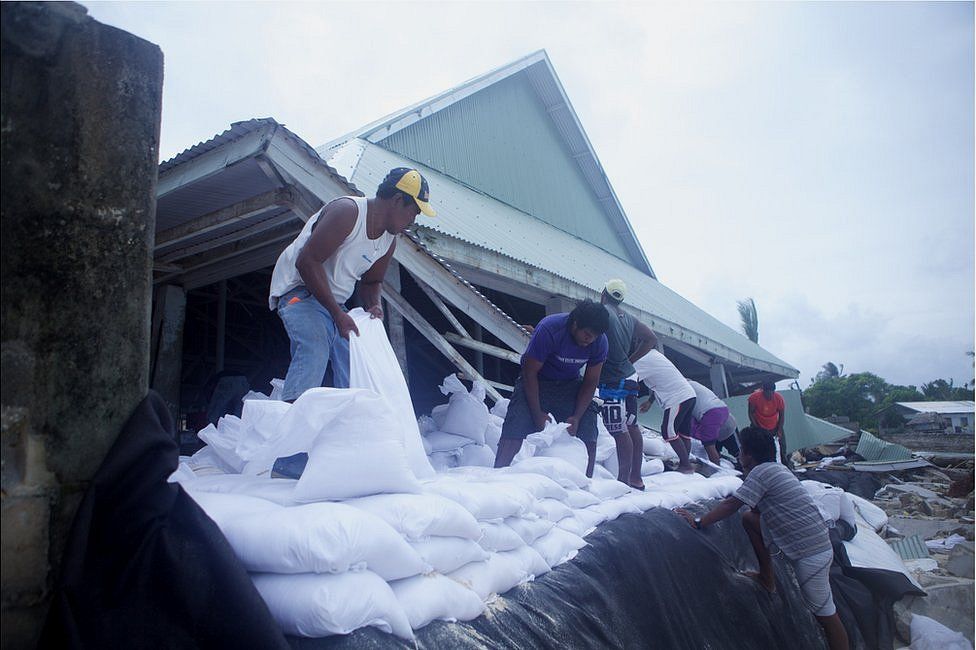 Picture of people filling up seawall bags in Kiribati