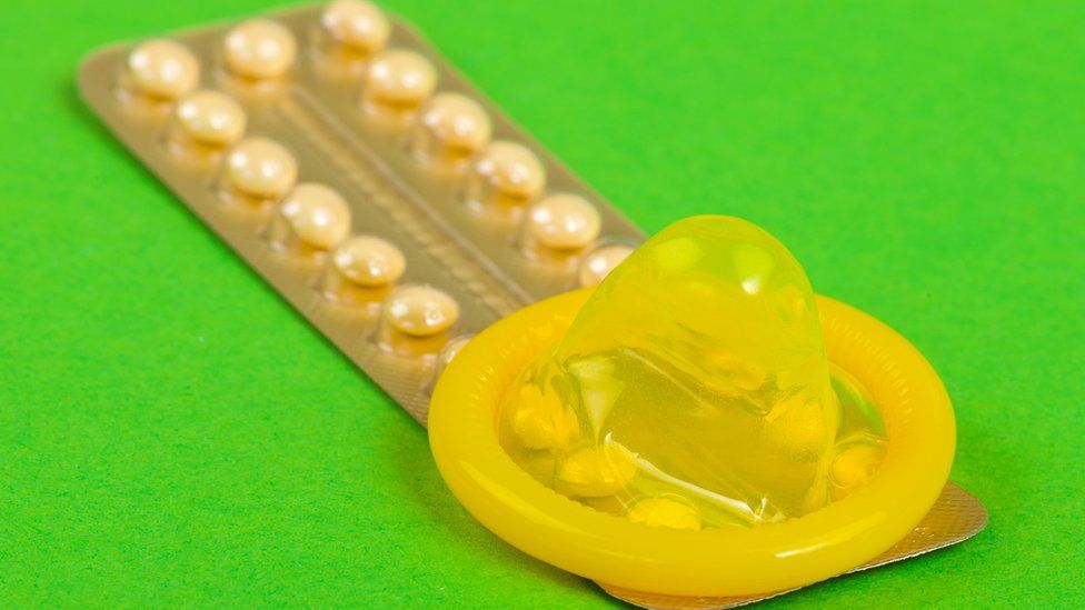 Pack of contraceptive pills and a condom