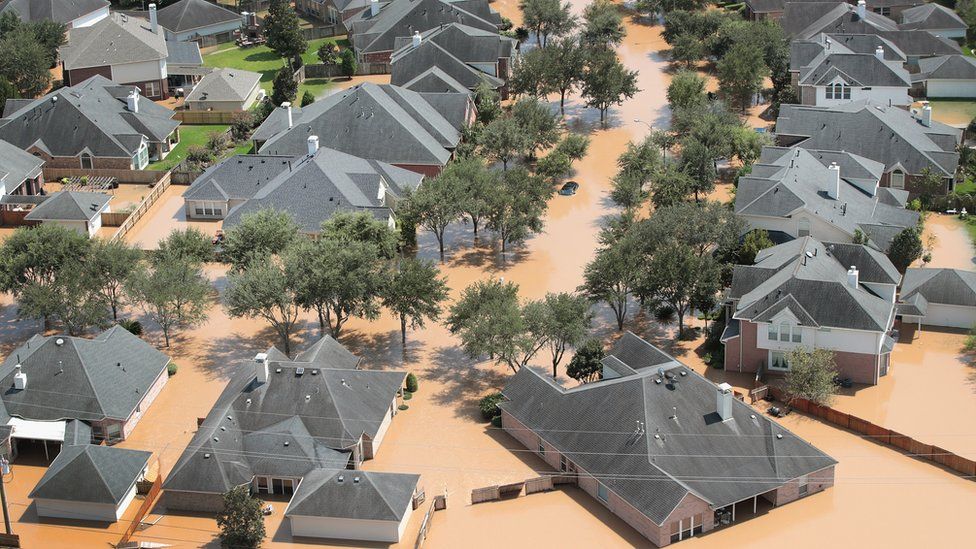An aerial view shows an entire neighbourhood under several inches of murky brown water in Sugar land, south-east Texas