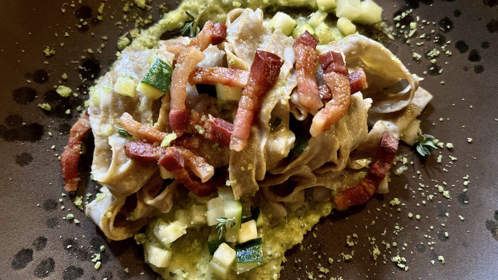 The cooked cricket tagliatelle is served with pancetta and courgette